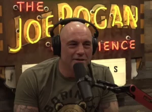 A screen-grab from the Joe Rogan Experience YouTube channel, showing Joe Rogan sitting behind a microphone.