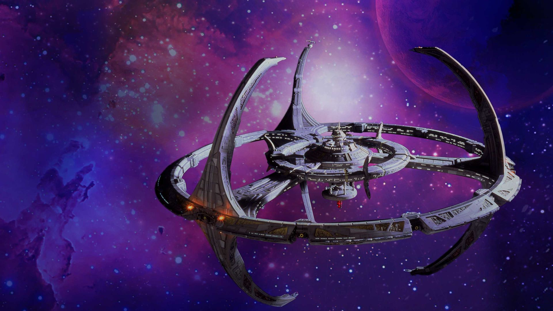 A still from the show Star Trek Deep Space Nine showing the titular space station set against a star field background with purple and pink nebulae.